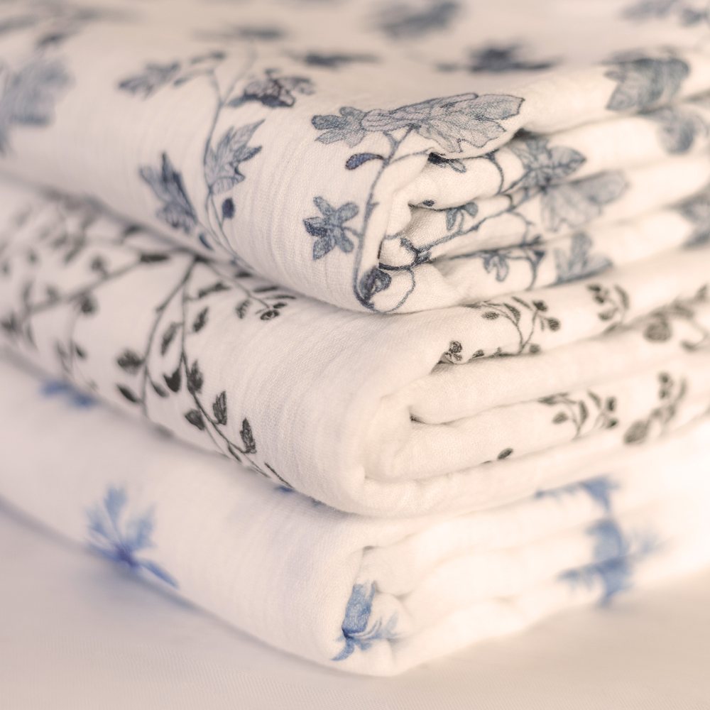 Fig, Snowberry and Cornflower swaddles folded in a stack